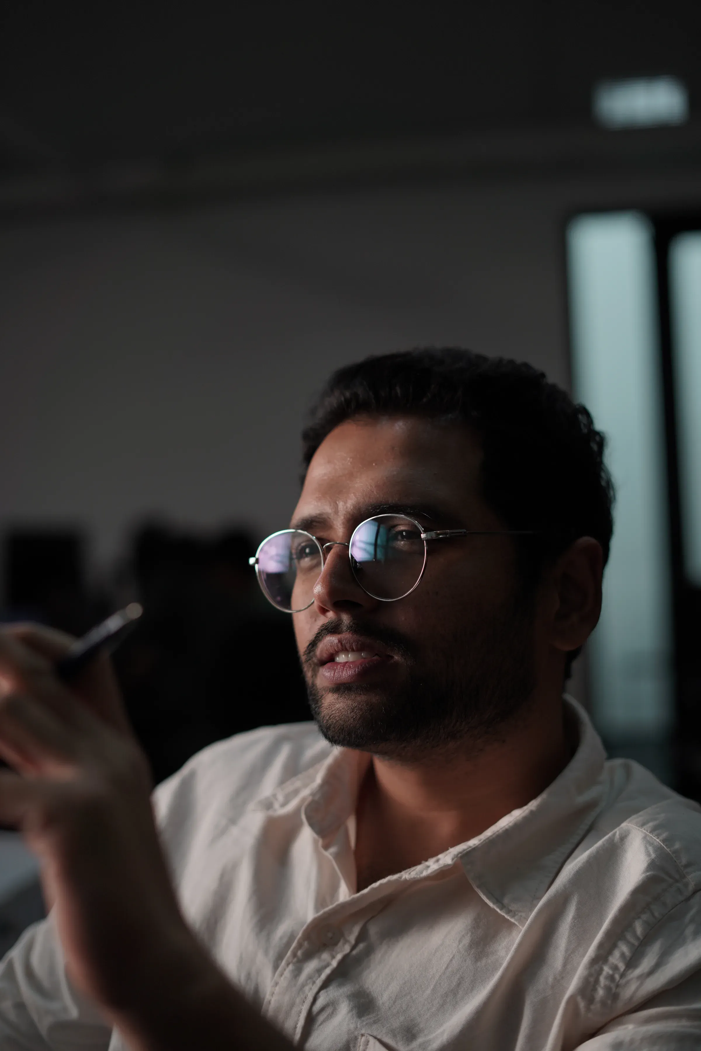 Close portrait of Ayushman Dash resting his chin on his hand, thinking