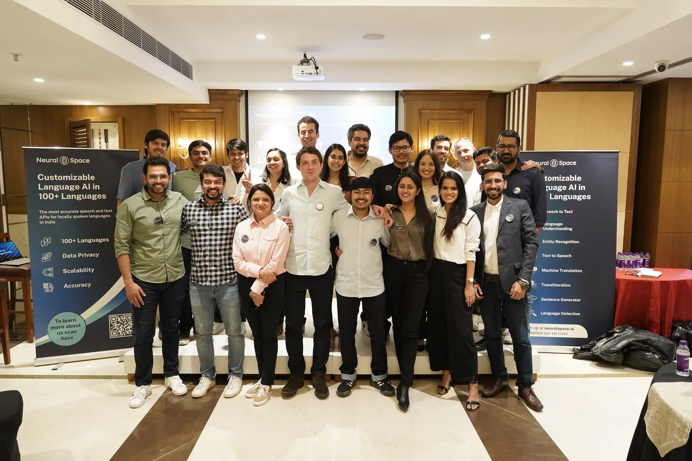 The NeuralSpace team together on stage at a company event in India